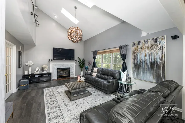 a living room with furniture a fireplace and a flat screen tv
