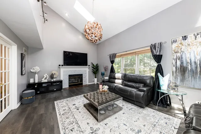 a living room with furniture a fireplace and a flat screen tv