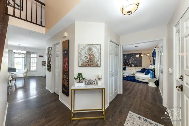 a view of a hallway view with living room and wooden floor