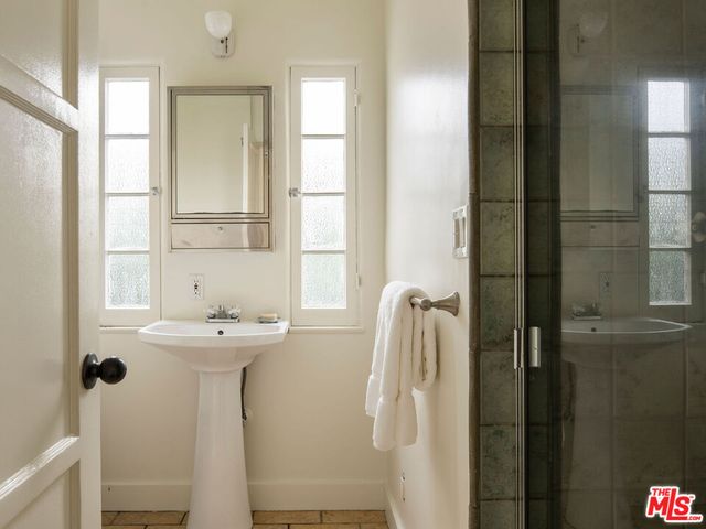 a view of patio with table and chairs and potted plants