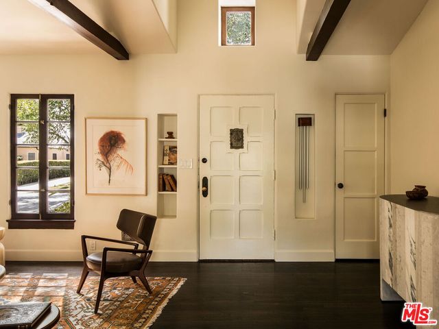 a view of a workspace with wooden floor and a window