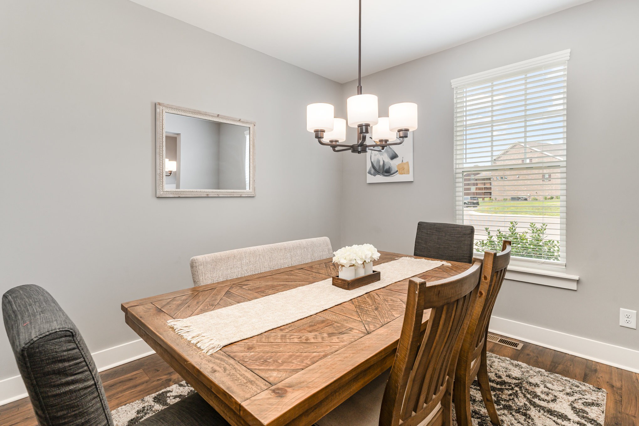 203 Caroline Way Mount Juliet, TN 37122 - Photo 4 of 37 a view of a dining room with furniture a chandelier and wooden floor