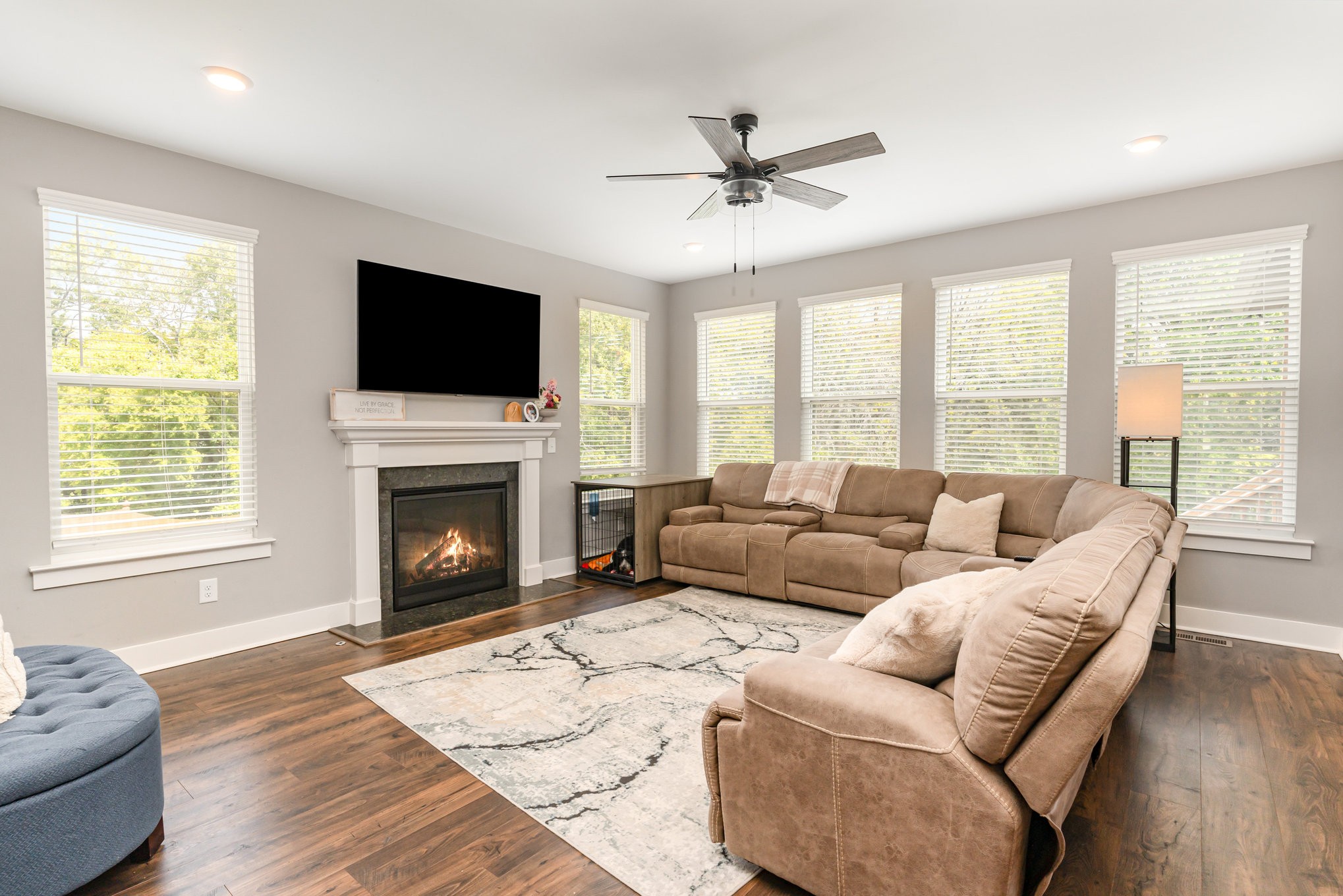 203 Caroline Way Mount Juliet, TN 37122 - Photo 8 of 37 a living room with furniture a flat screen tv and a fireplace