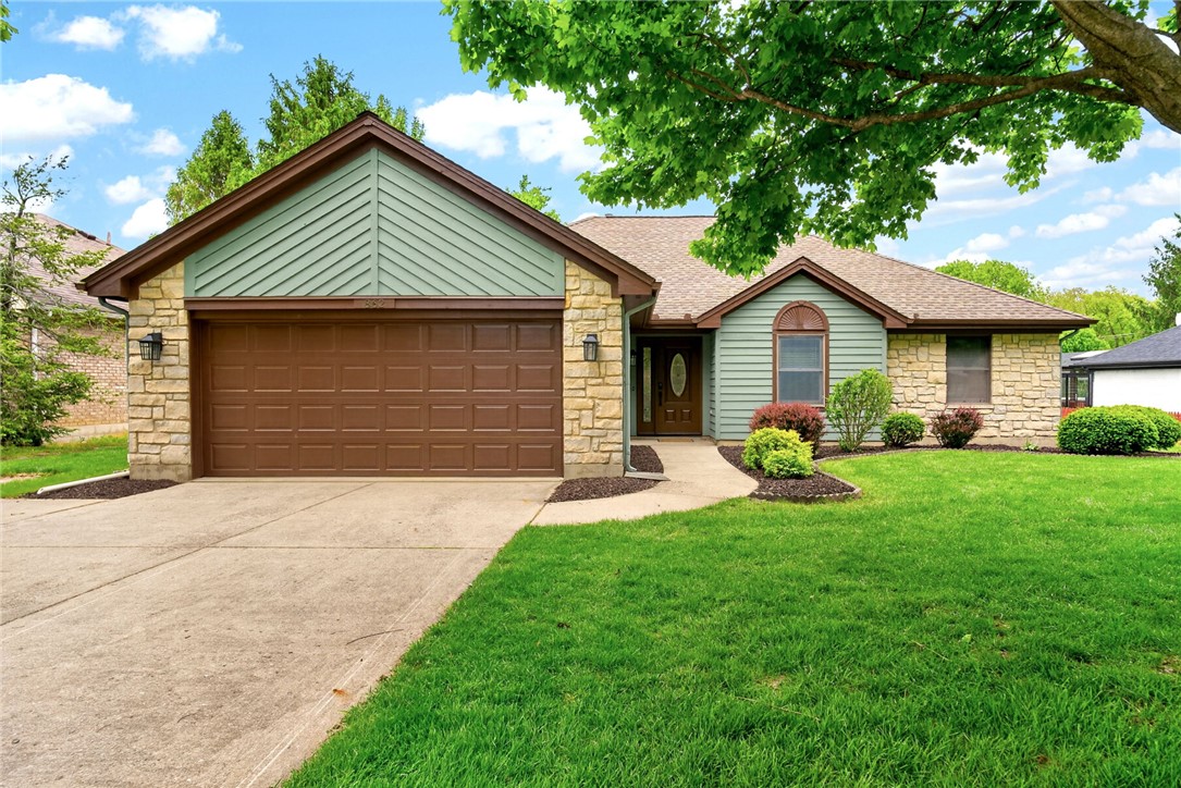 This charming home offers curb appeal with natural stone and lush landscaping.