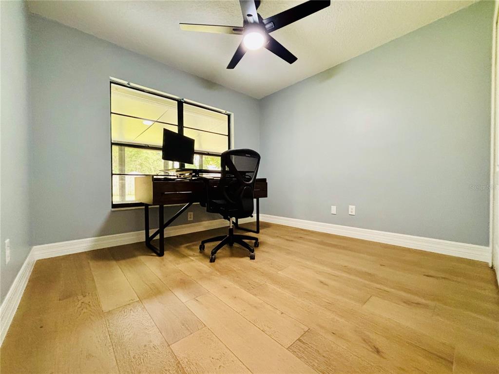 1045 Shaffer Trail Oviedo, FL 32765 - Photo 14 of 30 a view of a workspace with furniture and a window