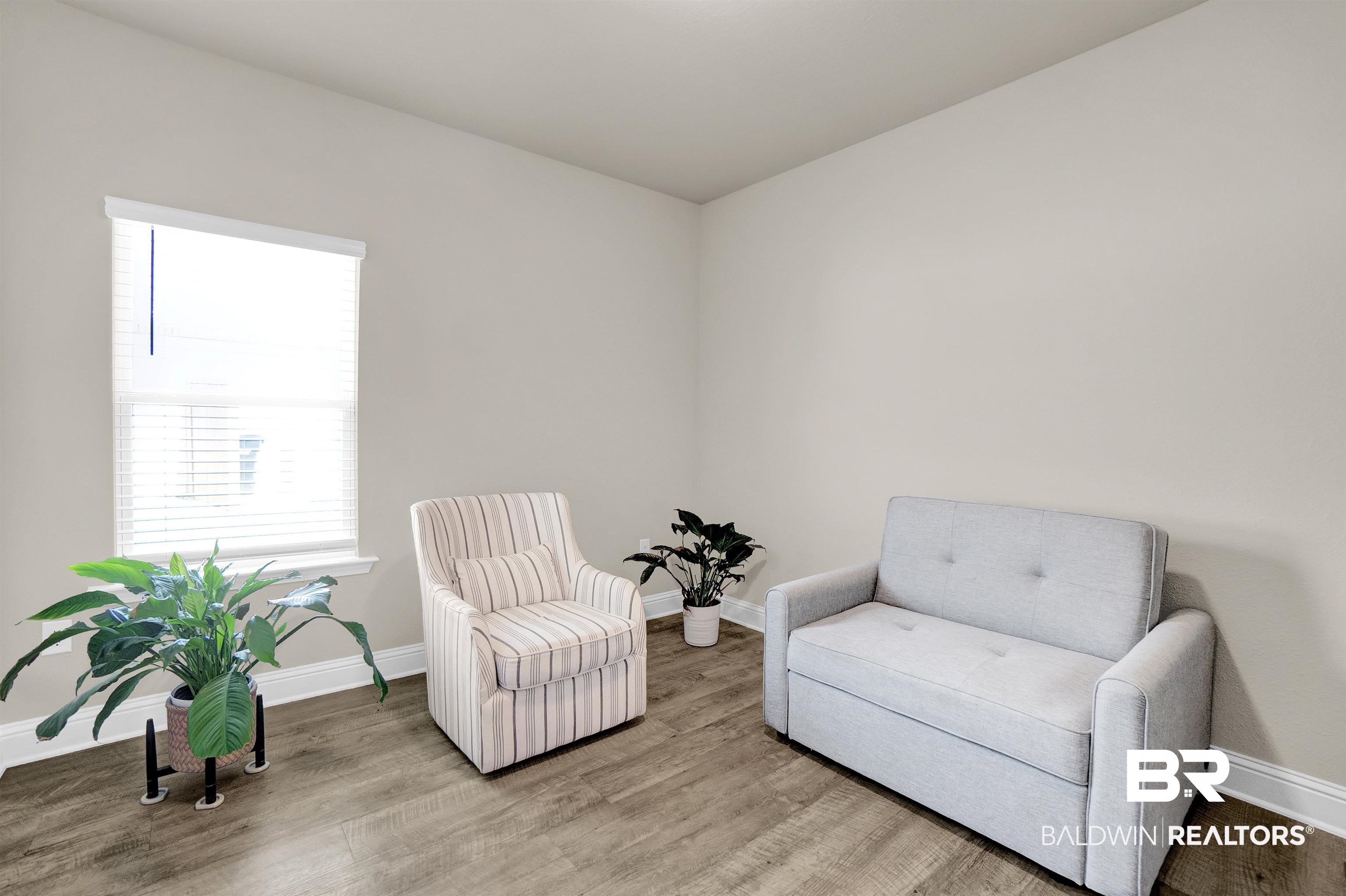 31671 Memphis Loop Daphne, AL 36527 - Photo 15 of 51 Living area featuring baseboards and wood finished floors