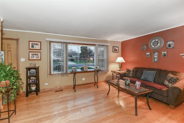10818 Austin Avenue Chicago Ridge, IL 60415 - Photo 2 of 16 a living room with furniture and a large window