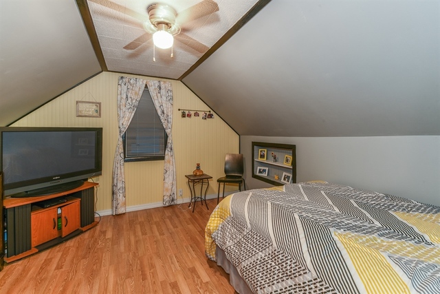 10818 Austin Avenue Chicago Ridge, IL 60415 - Photo 12 of 16 a bedroom with a bed and a flat screen tv
