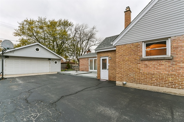 10818 Austin Avenue Chicago Ridge, IL 60415 - Photo 16 of 16 a view of a house with a yard and garage