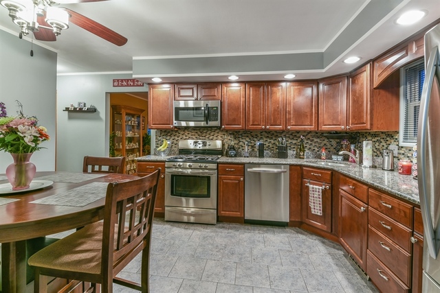 10818 Austin Avenue Chicago Ridge, IL 60415 - Photo 4 of 16 a kitchen with stainless steel appliances granite countertop a stove a sink and a refrigerator