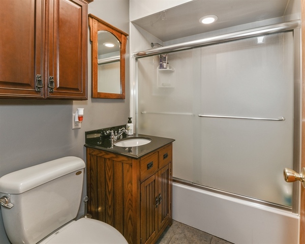 10818 Austin Avenue Chicago Ridge, IL 60415 - Photo 9 of 16 a bathroom with a sink a toilet and shower