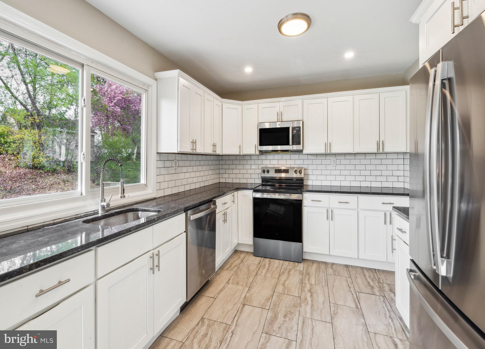 44 Pershing Lane Sicklerville, NJ 08081 - Photo 2 of 24 a kitchen with stainless steel appliances granite countertop a refrigerator sink and stove