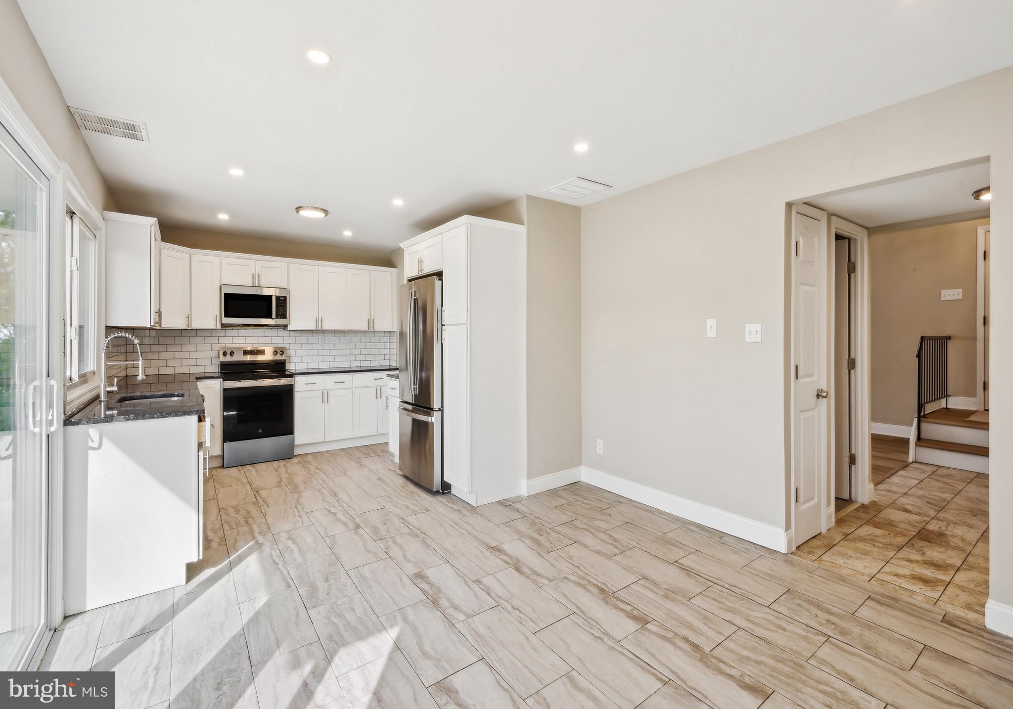 44 Pershing Lane Sicklerville, NJ 08081 - Photo 5 of 24 a kitchen with stainless steel appliances granite countertop a refrigerator and a stove top oven
