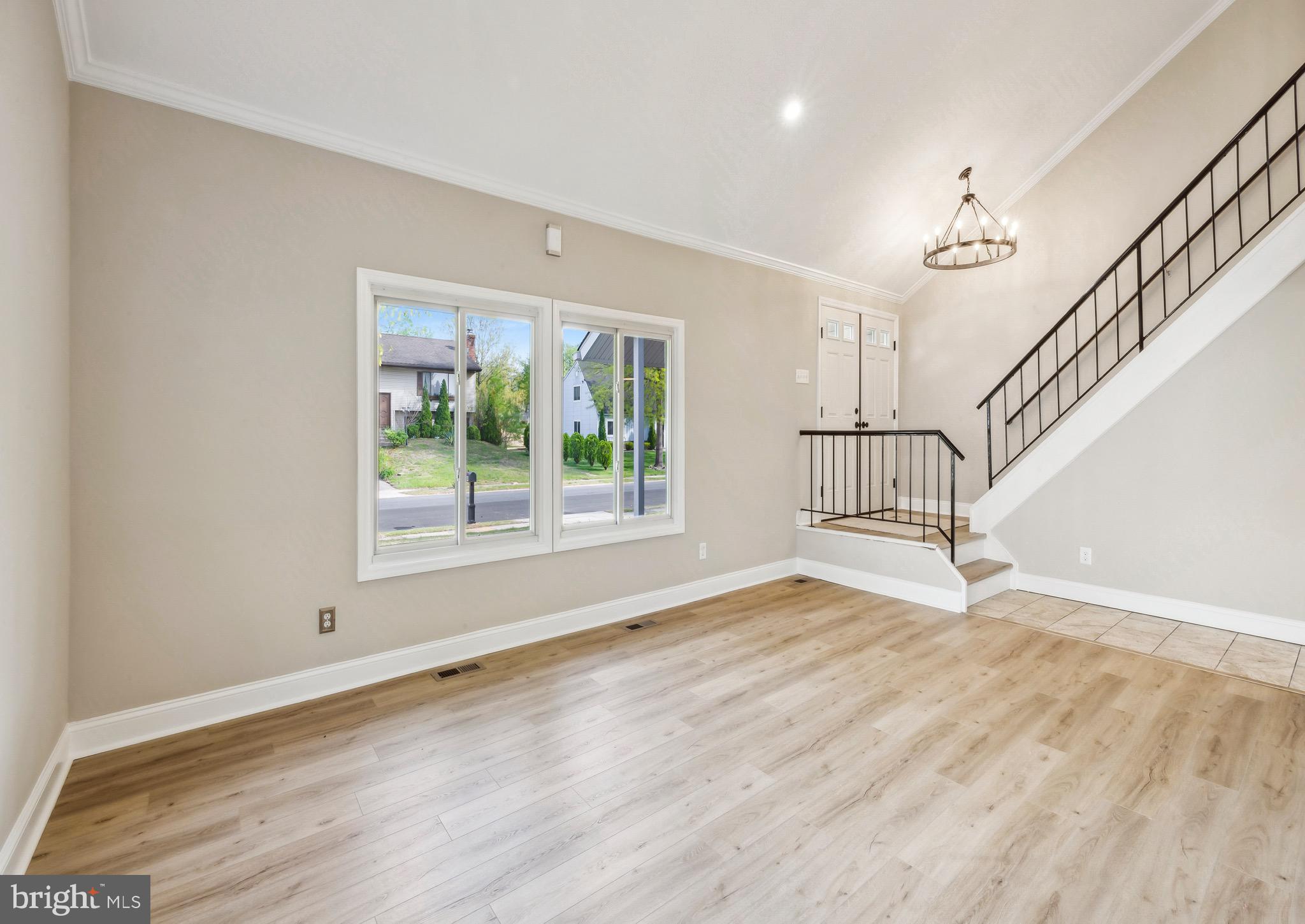44 Pershing Lane Sicklerville, NJ 08081 - Photo 7 of 24 a view of an empty room with wooden floor and a window