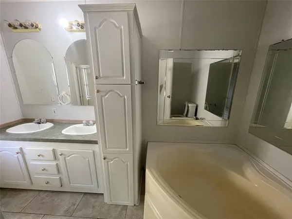 a bathroom with 2 sink and a mirror