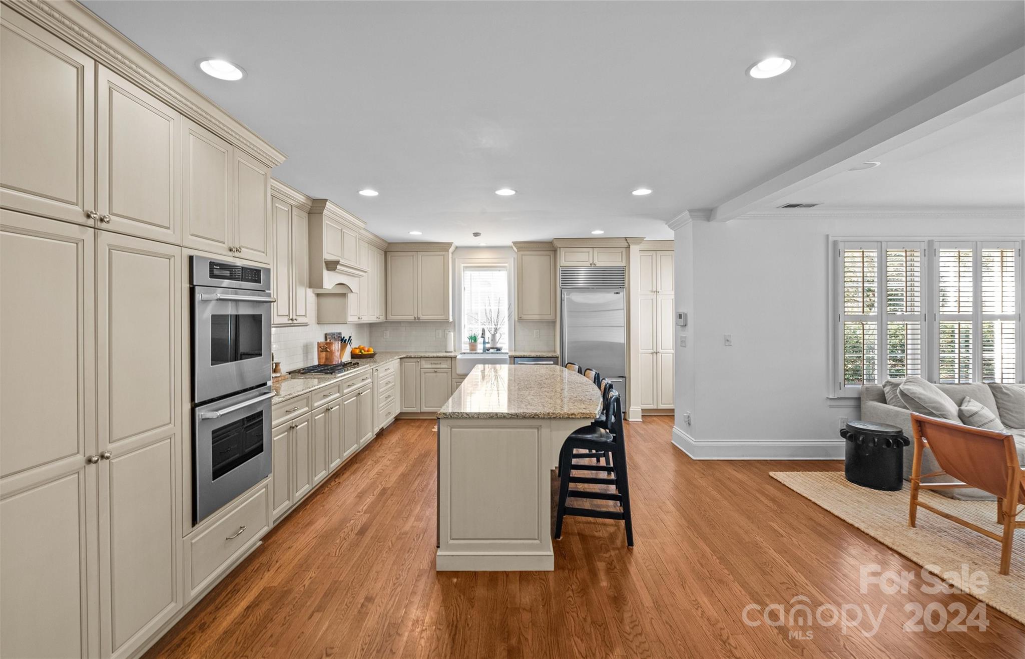 2326 Croydon Road Charlotte, NC 28207 - Photo 12 of 44 a kitchen with stainless steel appliances granite countertop a refrigerator a stove top oven a sink dishwasher and white cabinets with wooden floor