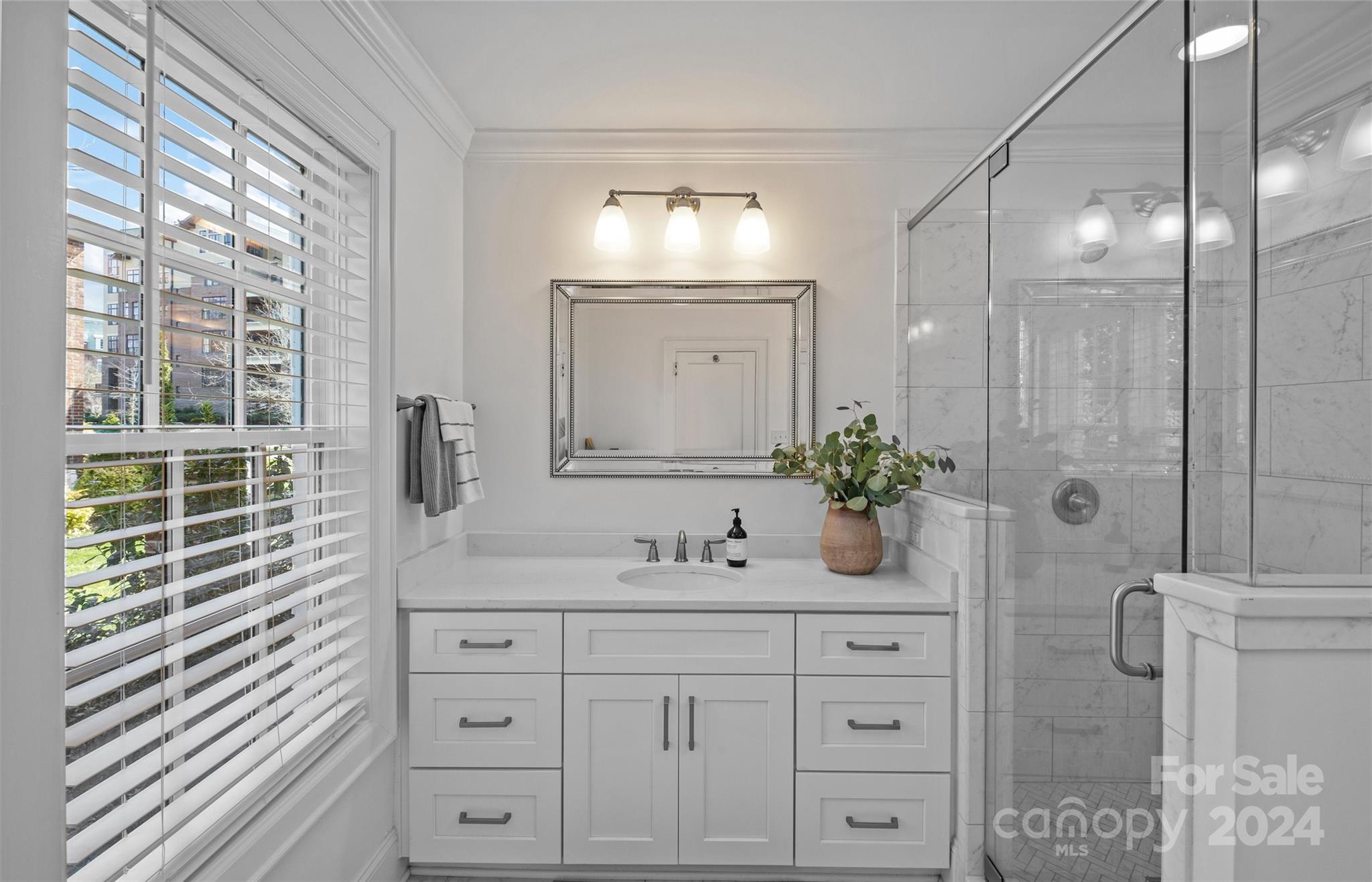 2326 Croydon Road Charlotte, NC 28207 - Photo 23 of 44 a bathroom with a granite countertop sink a mirror a window and a shower
