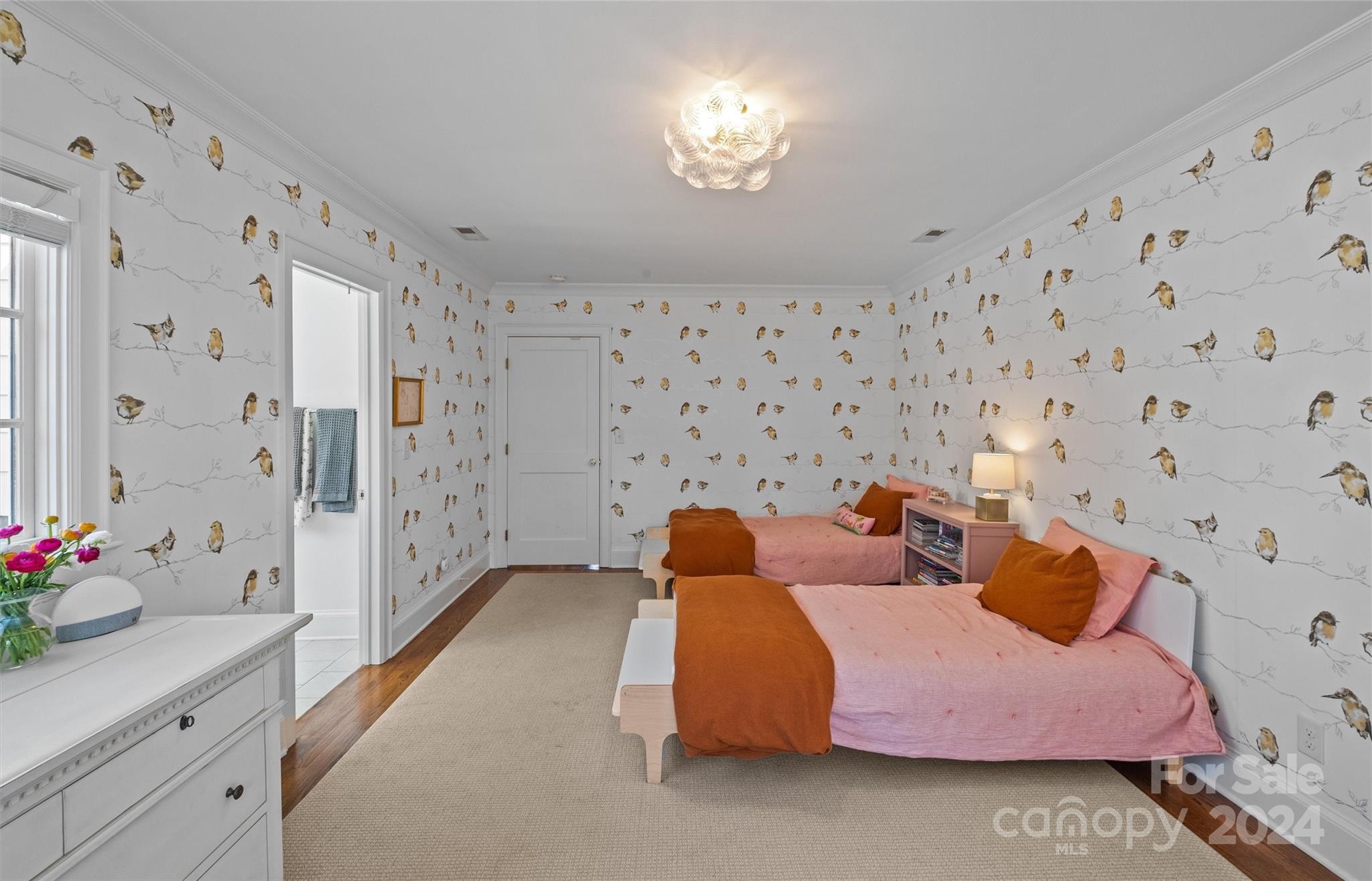 2326 Croydon Road Charlotte, NC 28207 - Photo 29 of 44 a bedroom with a bed and a chandelier