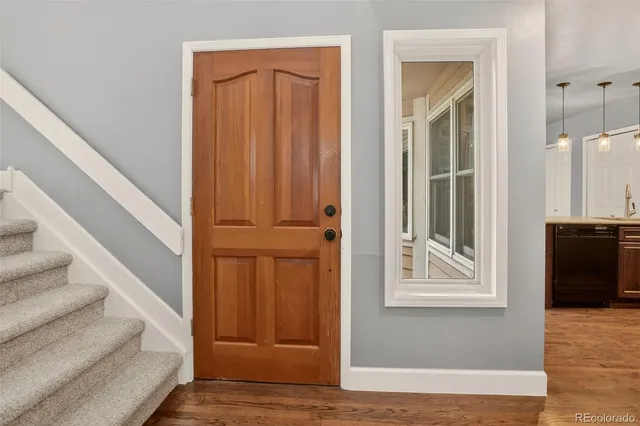 a view of entryway with wooden floor and stairs