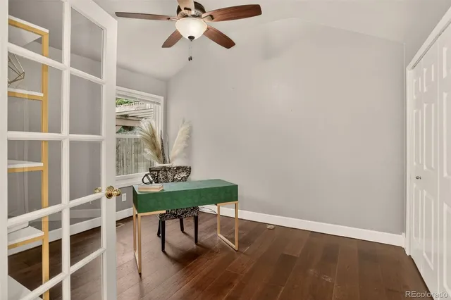 a view of a workspace with furniture and wooden floor