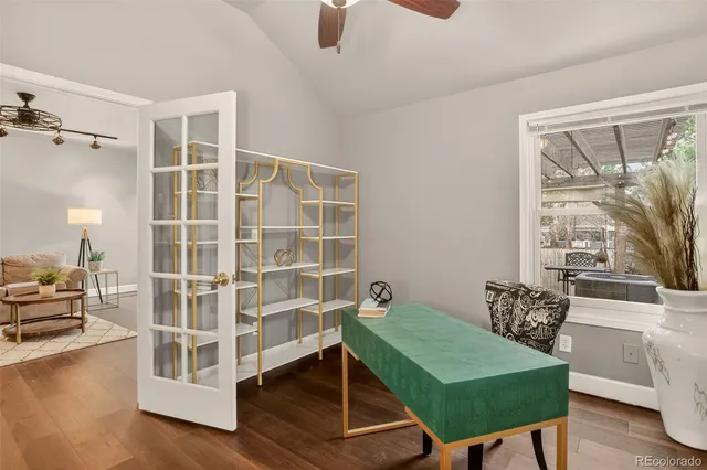 a view of a workspace with furniture and a window