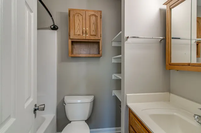a bathroom with a sink a toilet and tub