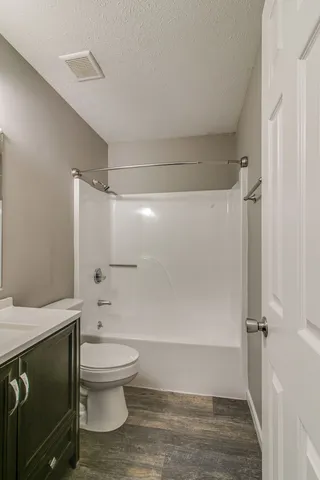a bathroom with a toilet and a shower