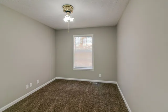 an empty room with a empty space and a window