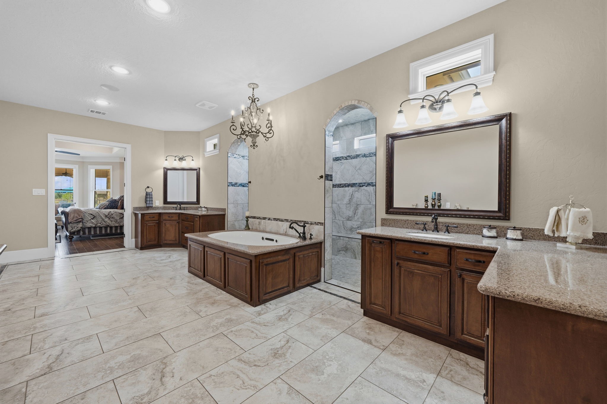 21620 Schiel Road Cypress, TX 77433 - Photo 21 of 49 The generously- sized primary bath has a spa tub with both air jets and water jets, a walk through shower, and ample storage.