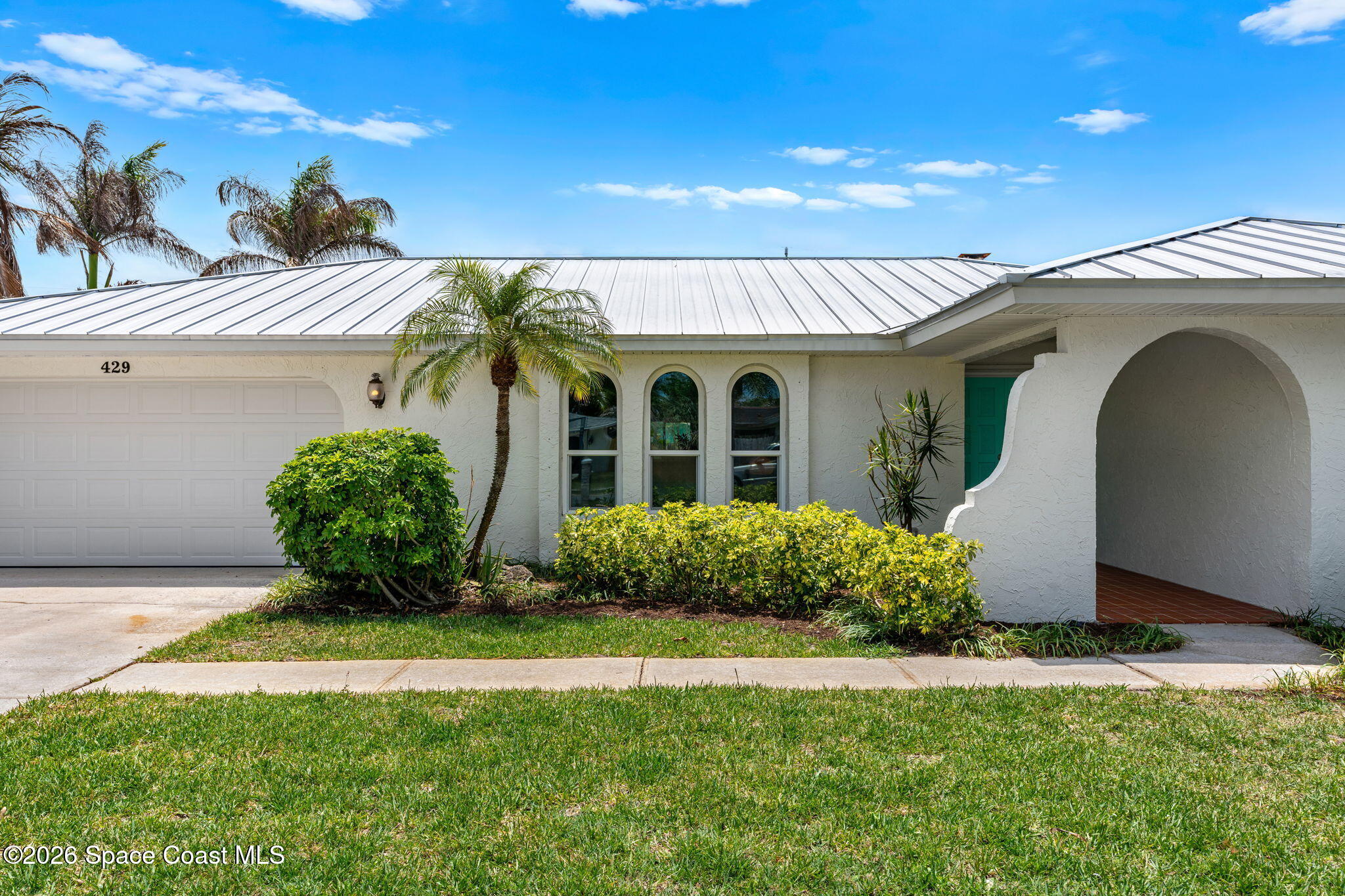 429 Rio Lane Indialantic, FL 32903 - Photo 1 of 50 a front view of a house with garden