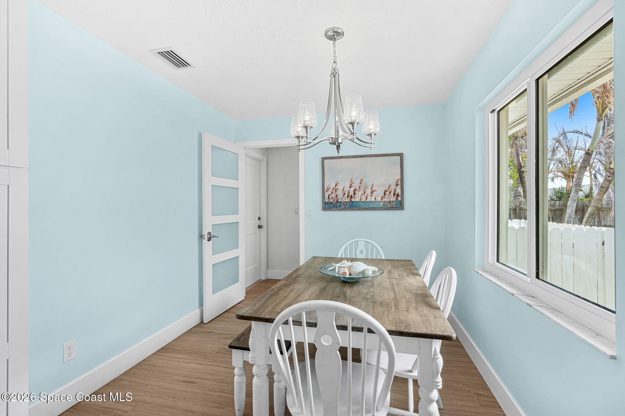 429 Rio Lane Indialantic, FL 32903 - Photo 13 of 50 a view of a dining room with furniture wooden floor and chandelier