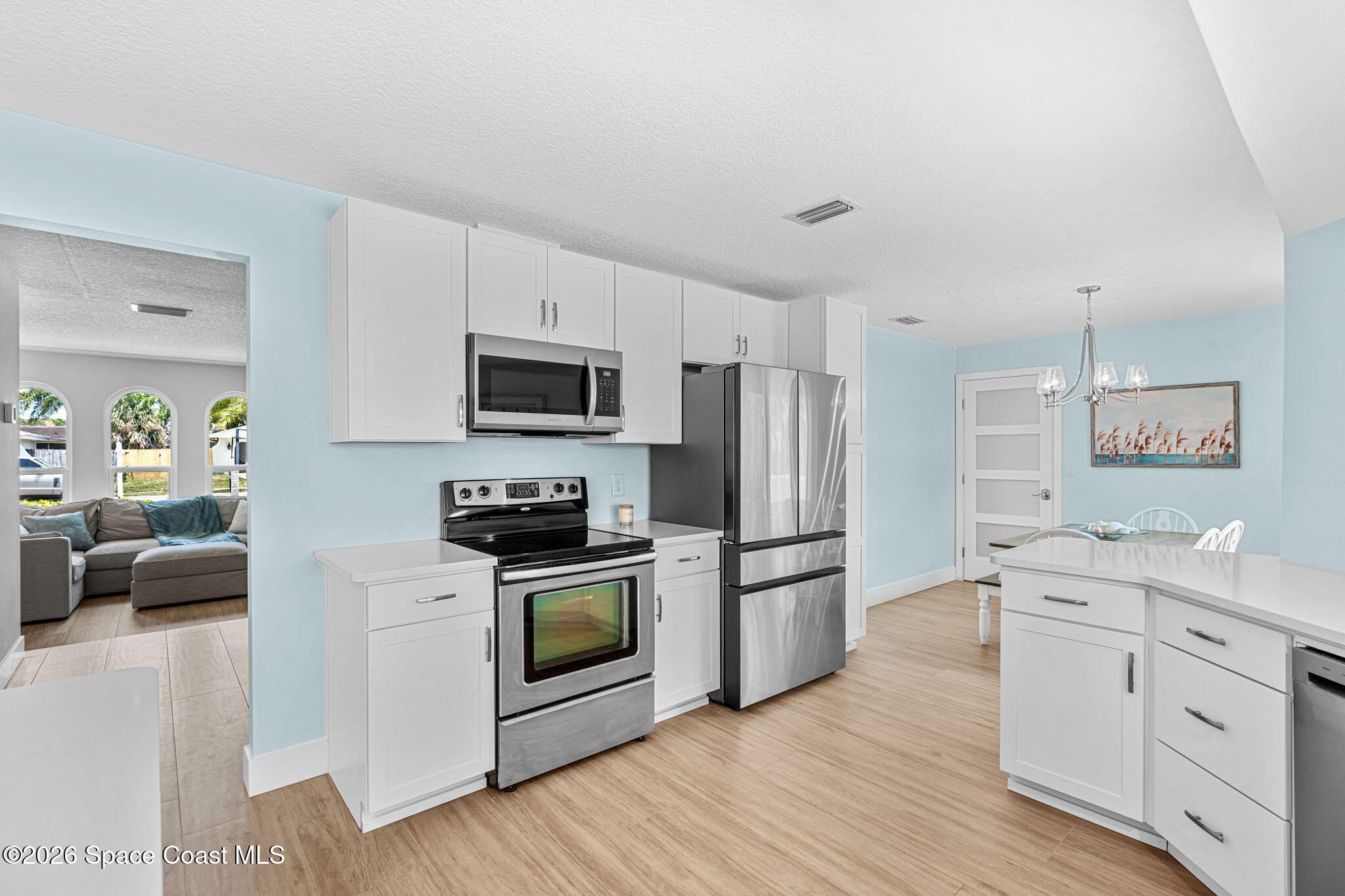 429 Rio Lane Indialantic, FL 32903 - Photo 16 of 50 a kitchen with stainless steel appliances a stove top oven a sink a refrigerator a cabinets and wooden floor