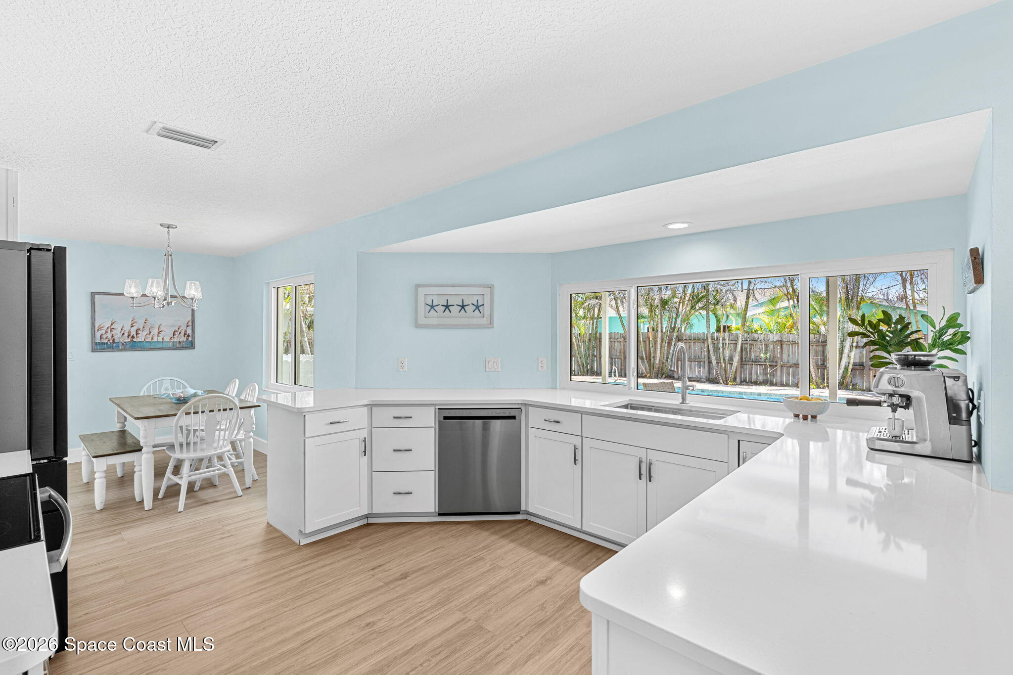 429 Rio Lane Indialantic, FL 32903 - Photo 18 of 50 a large white kitchen with cabinets and wooden floor