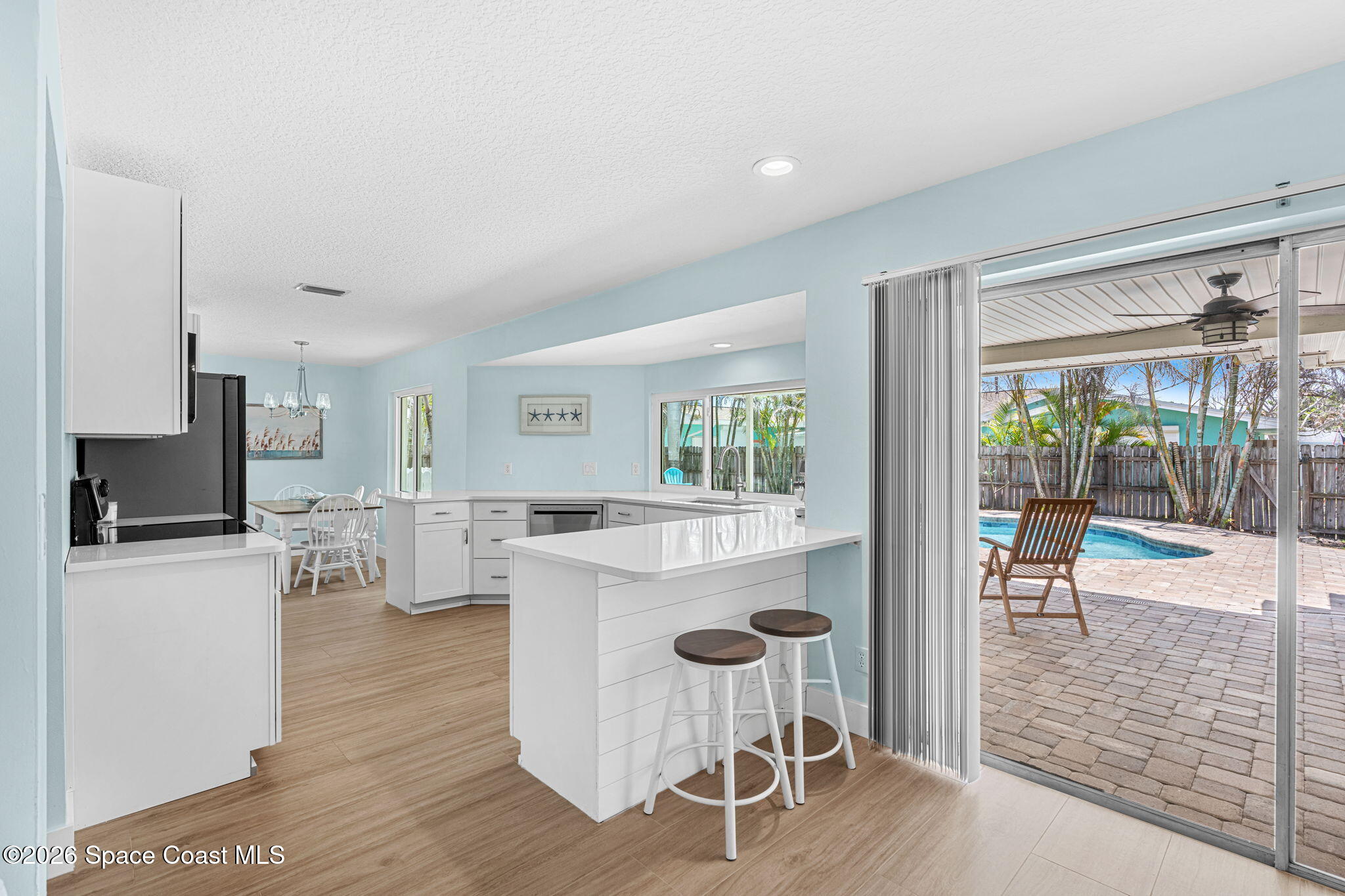 429 Rio Lane Indialantic, FL 32903 - Photo 20 of 50 a living room with furniture a large window and wooden floor