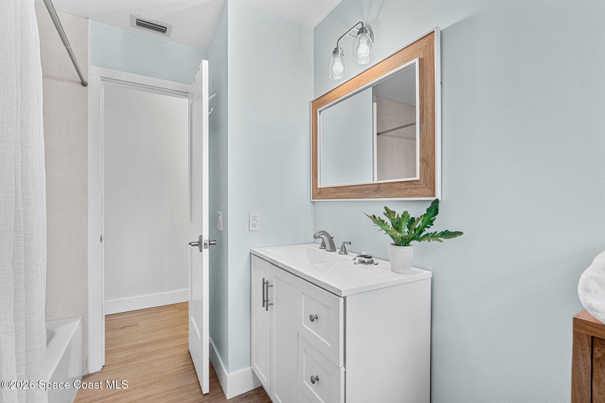 429 Rio Lane Indialantic, FL 32903 - Photo 29 of 50 a bathroom with a sink a mirror and a potted plant