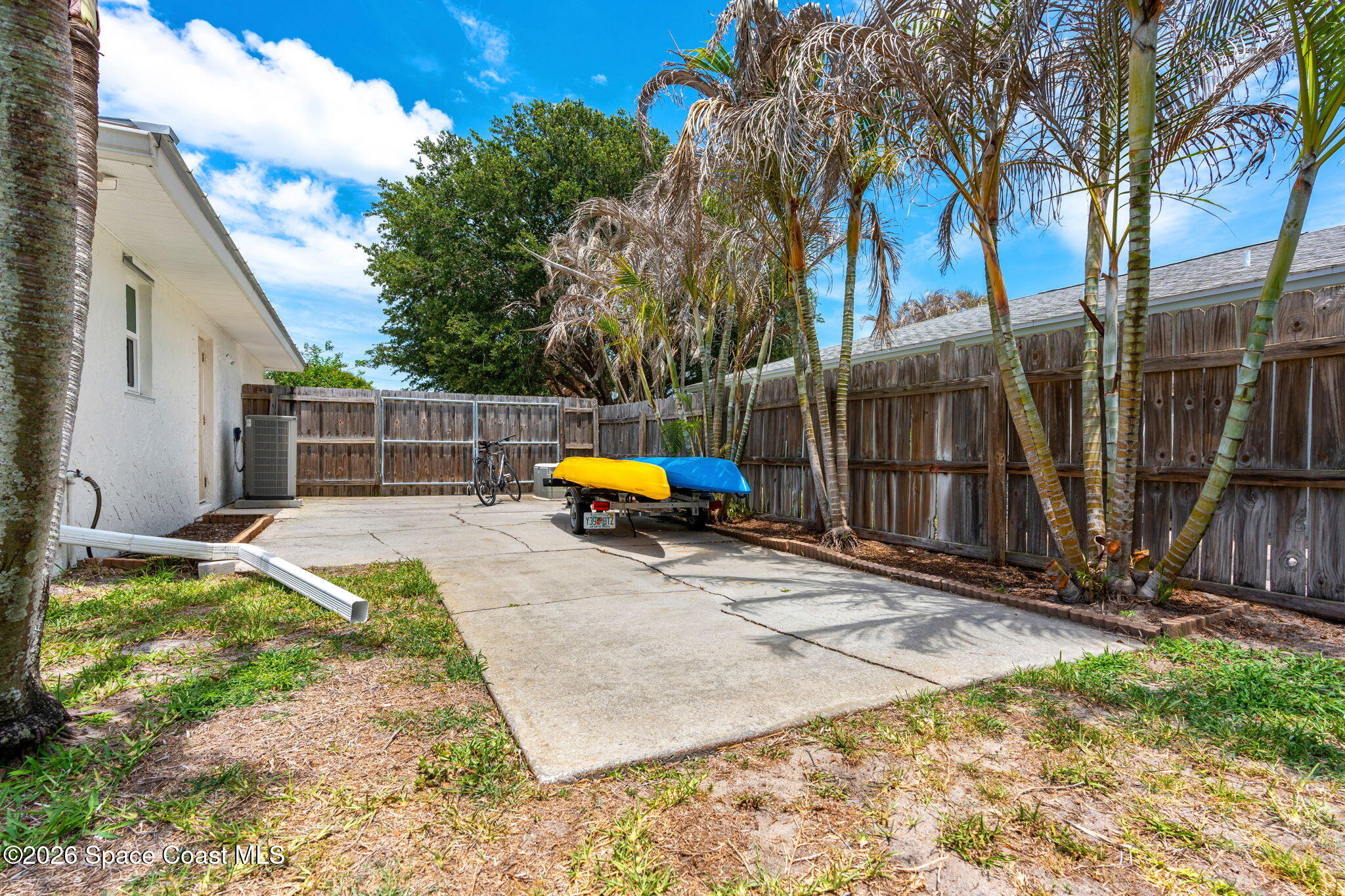 429 Rio Lane Indialantic, FL 32903 - Photo 39 of 50 a backyard of a house with barbeque oven table and chairs