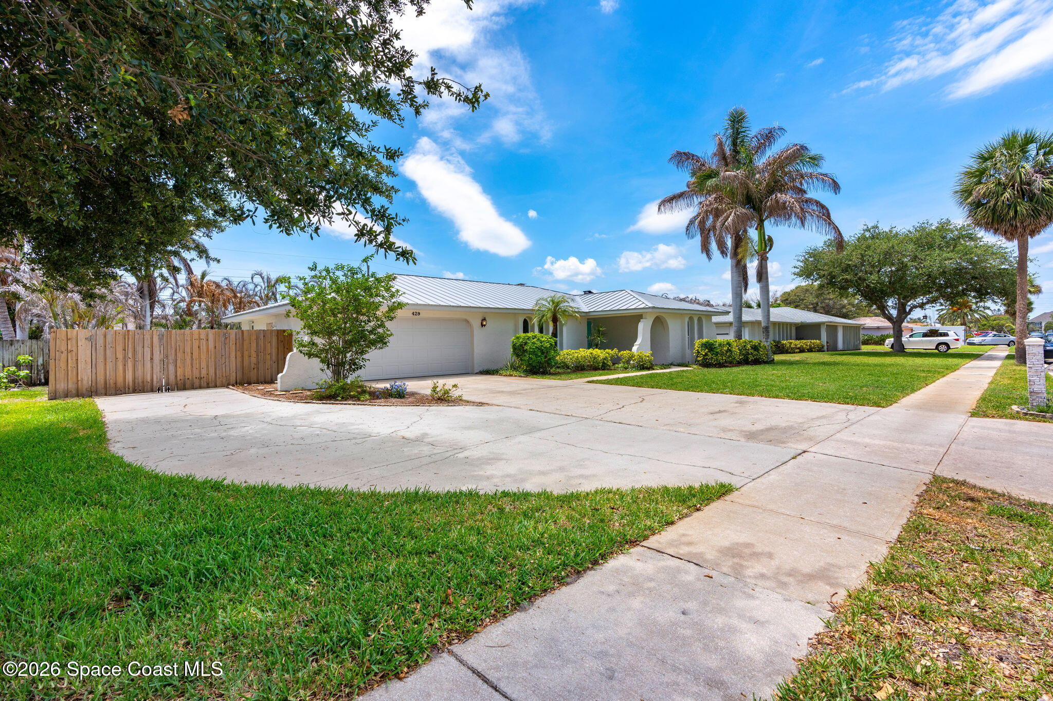 429 Rio Lane Indialantic, FL 32903 - Photo 42 of 50 a front view of a house with a yard and potted plants