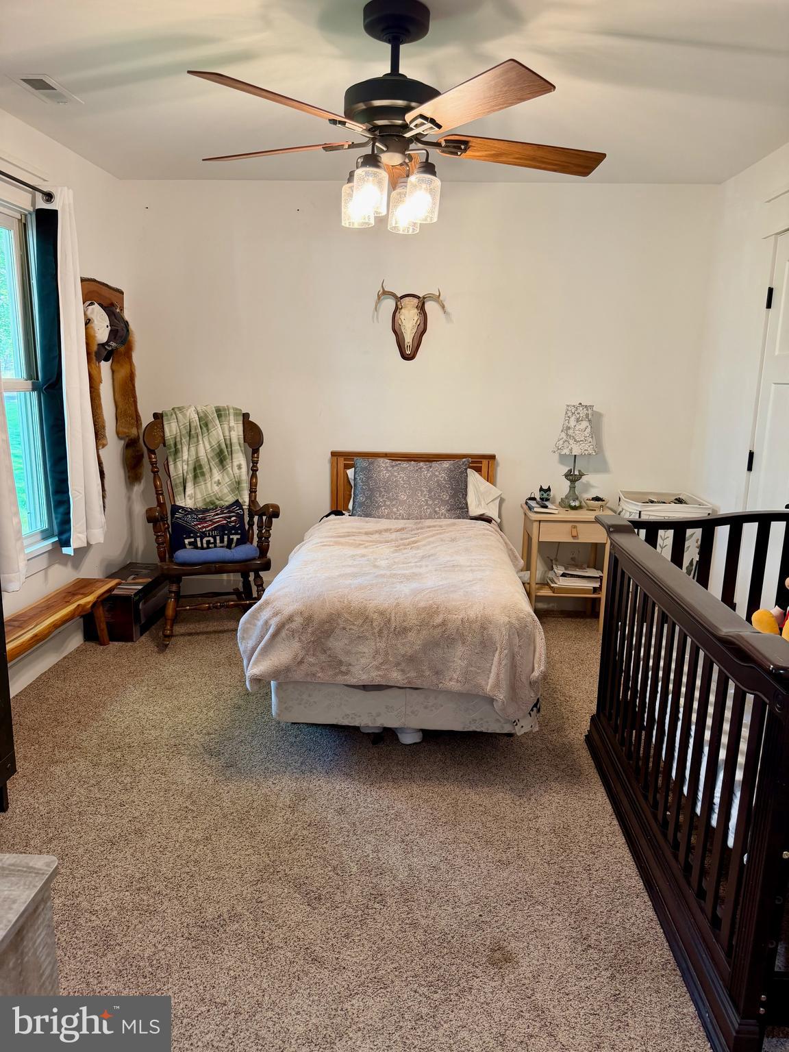 943 Sackettsford Road Warminster, PA 18974 - Photo 13 of 28 a bedroom with a bed and a chandelier