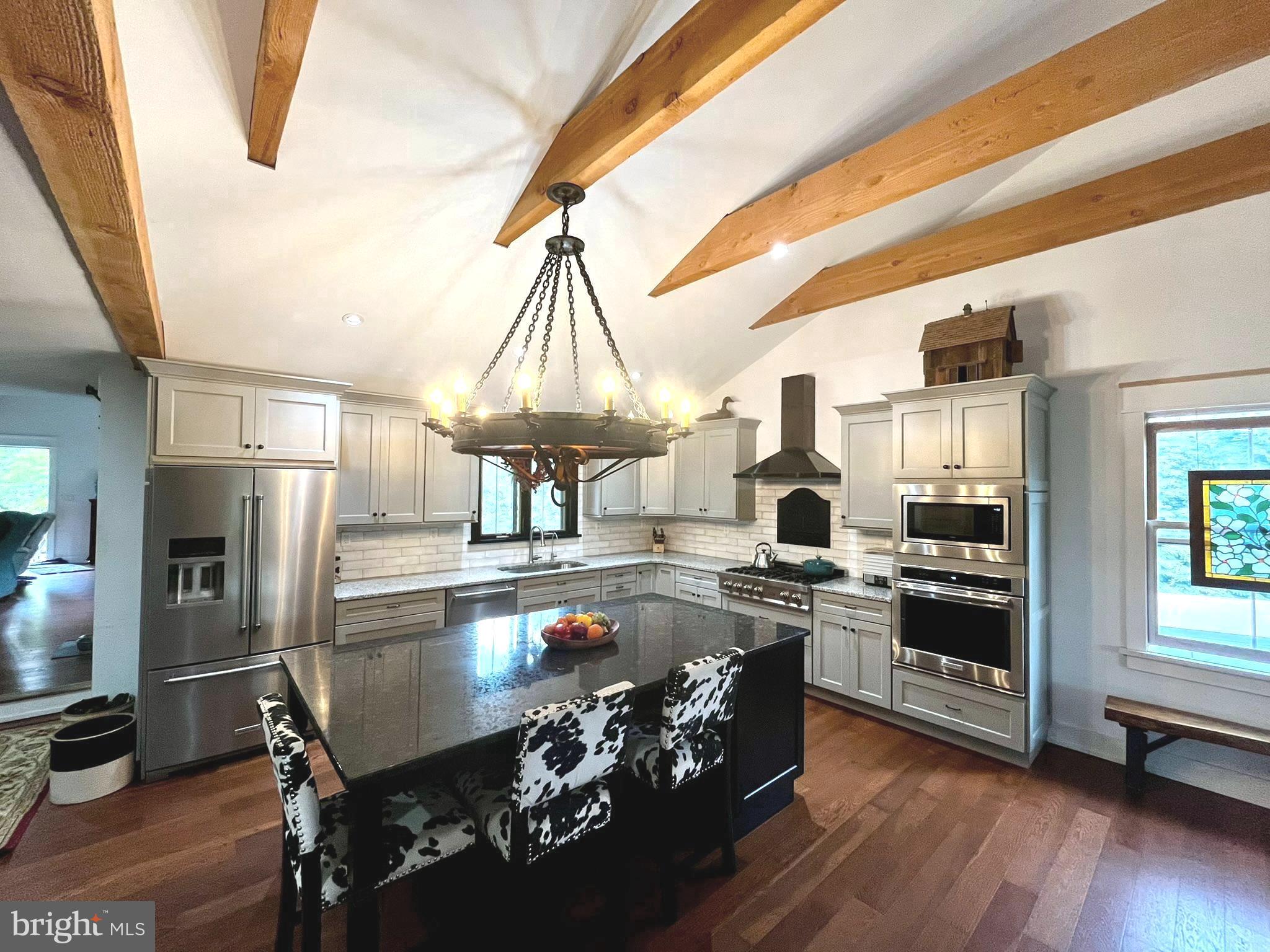 943 Sackettsford Road Warminster, PA 18974 - Photo 2 of 28 a kitchen with kitchen island a large counter top space and stainless steel appliances