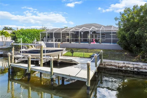 a aerial view of a house with swimming pool and a yard