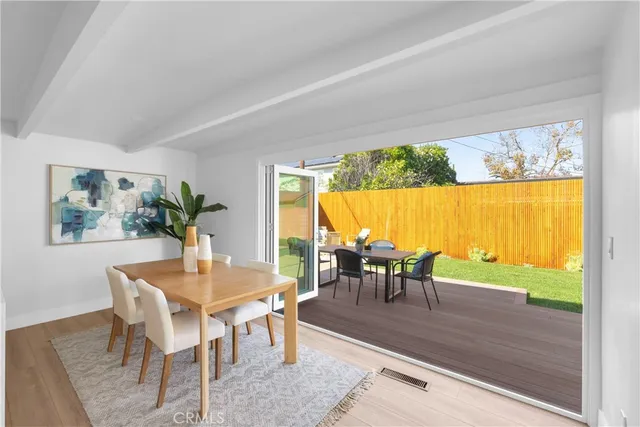 a dining room with furniture window and wooden floor