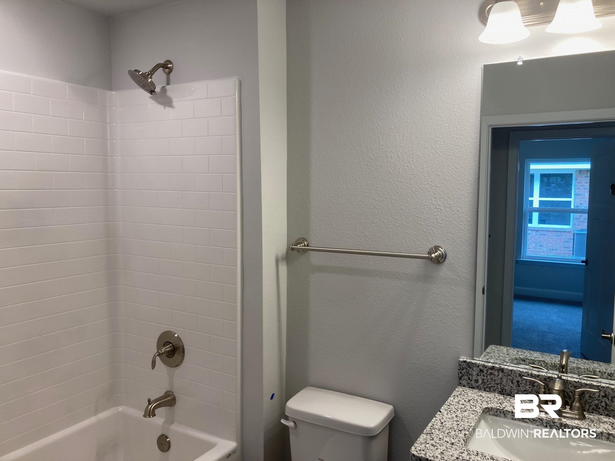 649 Revere Street Foley, AL 36535 - Photo 10 of 18 Bathroom featuring a textured wall, tub / shower combination, toilet, and vanity