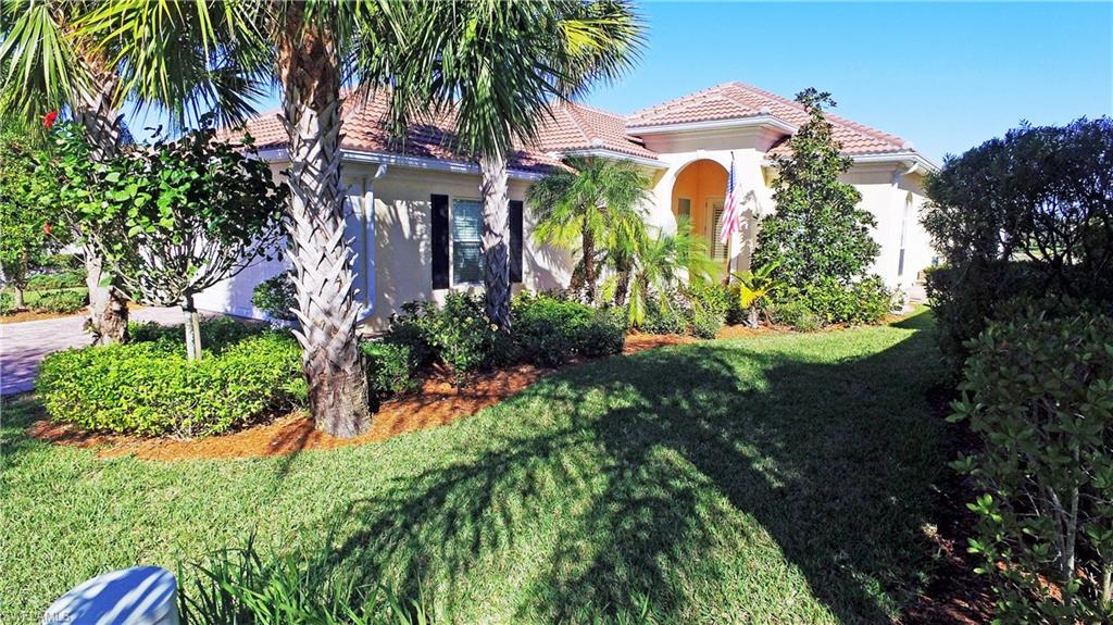 8821 Ravello Court Naples, FL 34114 - Photo 1 of 1 Inviting entry with paver brick driveway and mature landscaping.