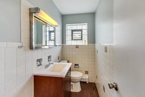 a bathroom with a sink a toilet and a window
