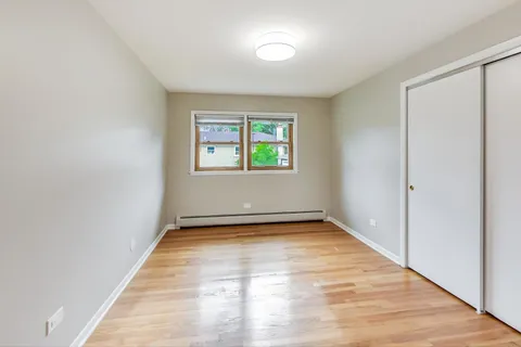 a view of a room with window and hardwood floor