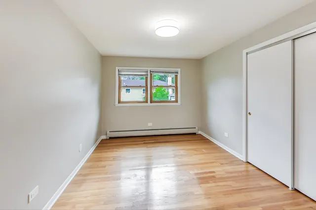 a view of a room with window and hardwood floor