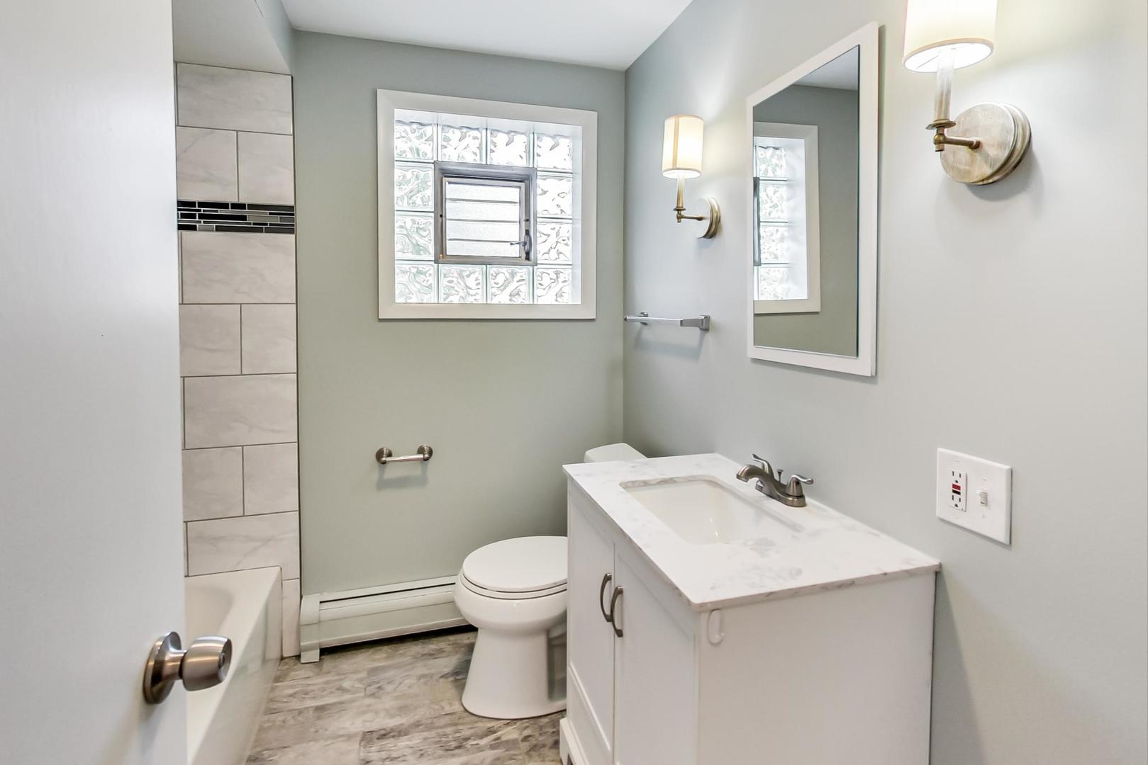 16W674 56th Place Clarendon Hills, IL 60514 - Photo 18 of 41 a bathroom with a sink a toilet and mirror