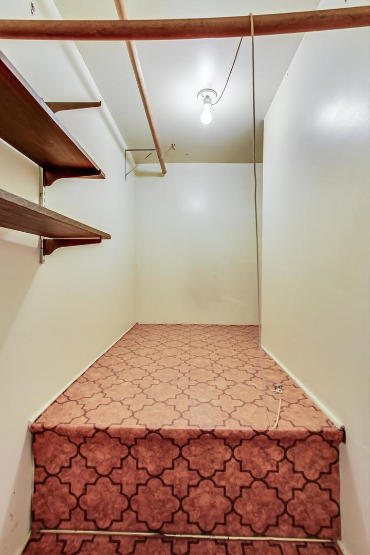 16W674 56th Place Clarendon Hills, IL 60514 - Photo 20 of 41 a bedroom with a bed and a window