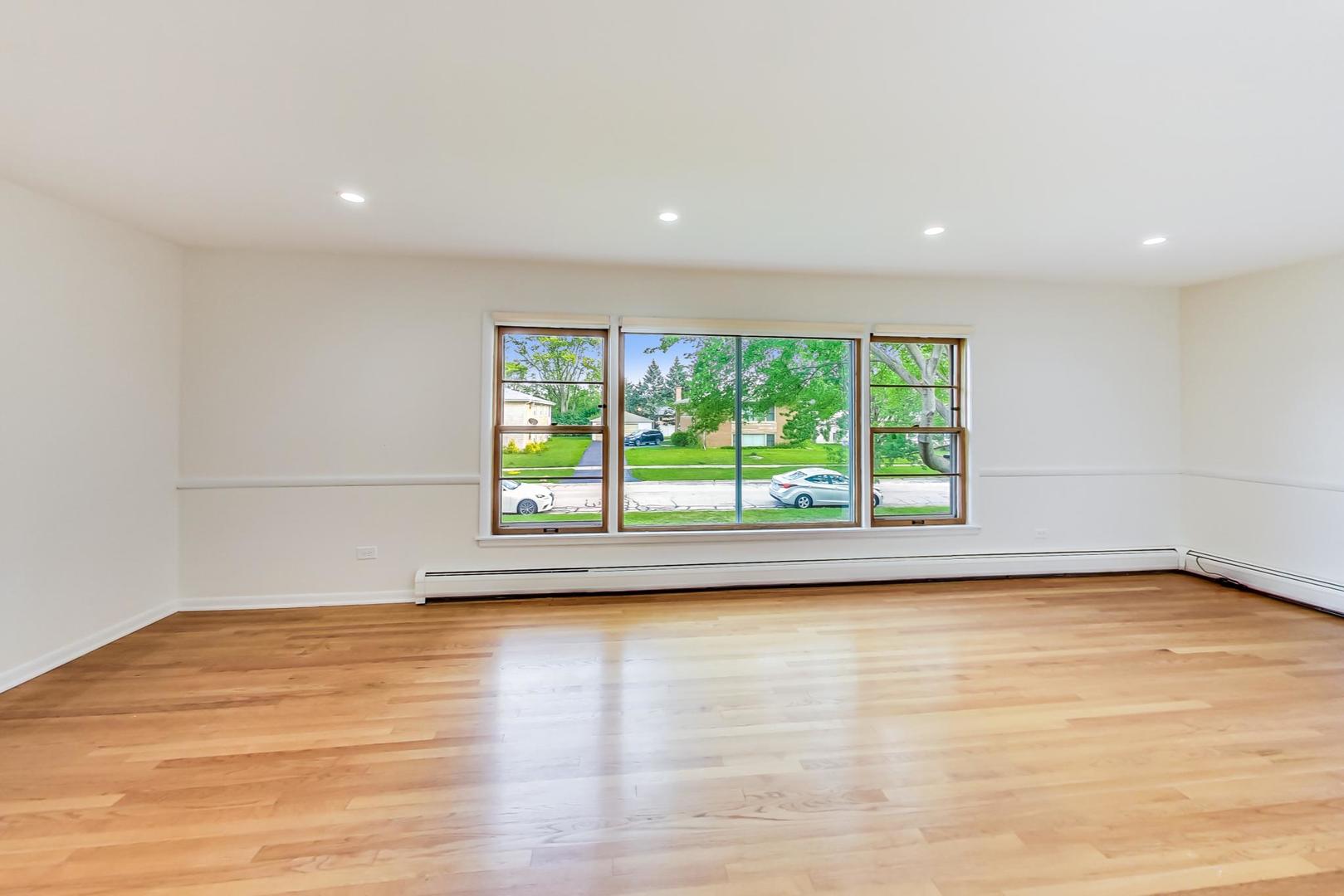 16W674 56th Place Clarendon Hills, IL 60514 - Photo 2 of 41 a view of empty room with wooden floor and fan