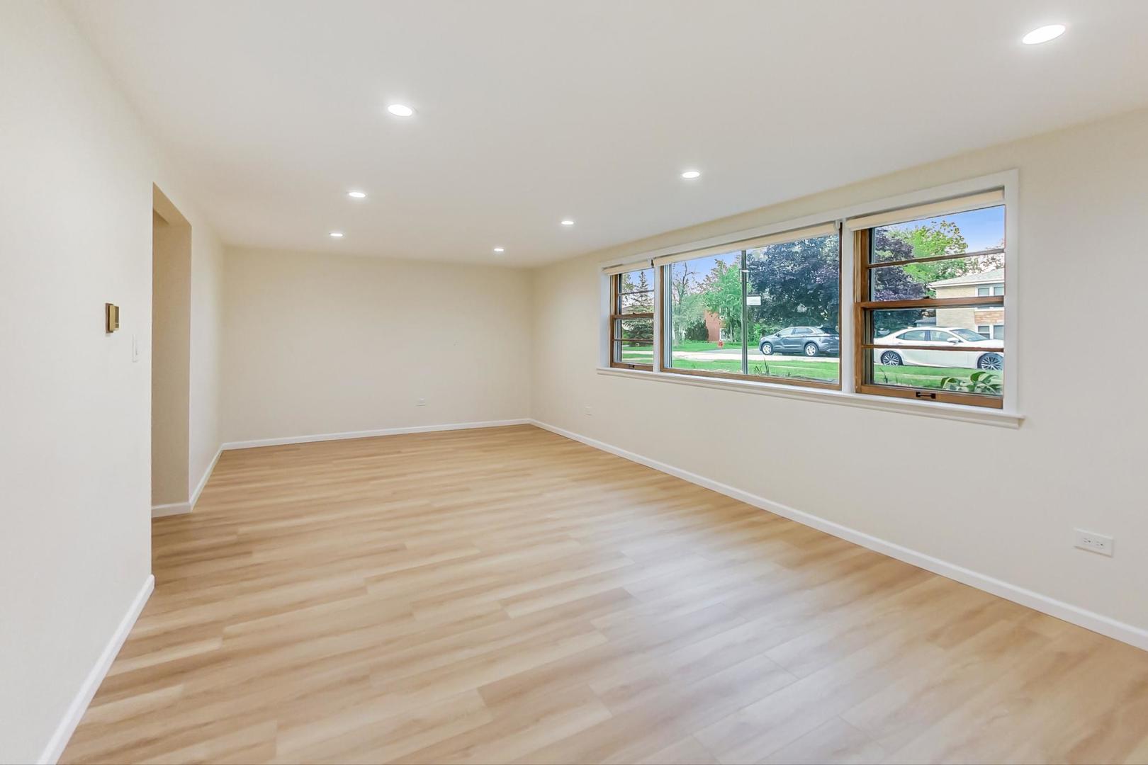 16W674 56th Place Clarendon Hills, IL 60514 - Photo 24 of 41 an empty room with wooden floor and windows